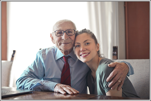 Senior man smiling with his grand-daughter